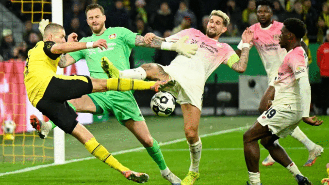 Dortmund's German defender, Waldemar Anton, Bayer Leverkusen Dutch goalkeeper Mark Flekken and Bayer Leverkusen's German midfielder Robert Andrich